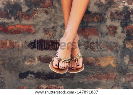 woman legs in  summer flat slippers outdoor day  shot  in city