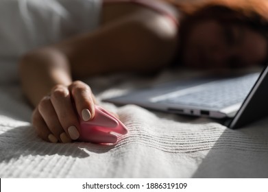 A Woman Lies In Bed Holding A Clitoral Vibrator And Watching Porn On A Laptop. The Girl Has Sex Online