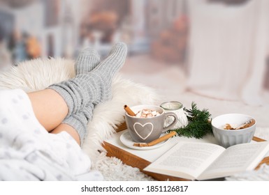 Woman Lies With Cup; Kako; Hot Chocolate; Marshmallows; Book Tray; Bed; Sofa; Blanket; Snuggle Blanket; Fur; Fireplace; Wind Light; Indoor; Living Room; Cosy; Reading; Enjoying; Relaxing; Winter Time