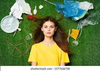 A woman lies on the grass disposable tableware plastic bags ecology Environmental pollution