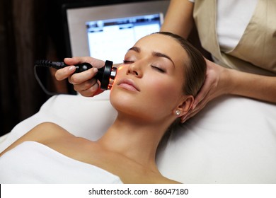 Woman lies on a table in a beauty spa getting a treatment