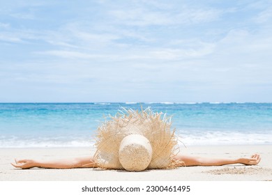 Woman lies on the white sand on the beach. Summer and vacation concept