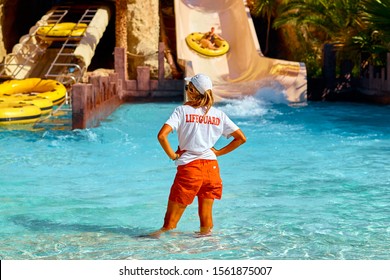 Woman Lifeguard At The Swimming Pool.