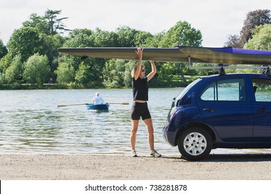 Woman Lifting Canoe Off Car