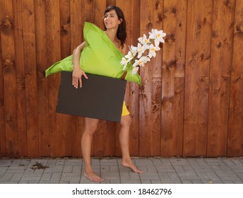 Woman Lifting Cardboard Box While Moving.