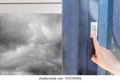 Woman Lifting Electric Shutters In Home For The Protection Of The Stormy Rain