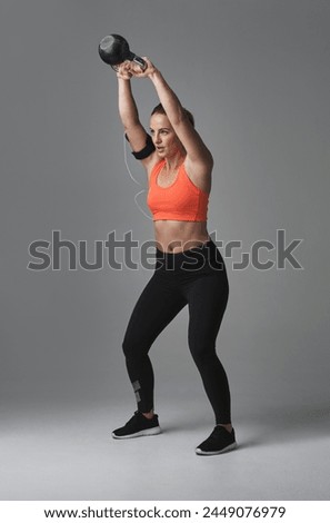 Similar – Image, Stock Photo One young athletic woman at crossfit training, exercising with trx suspension fitness straps over dark background, front view, looking at camera