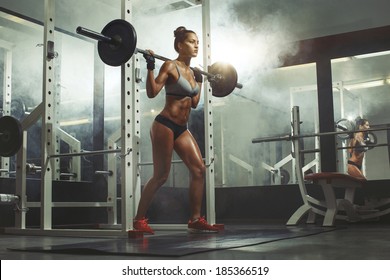 Woman Lifting Weight In Gym