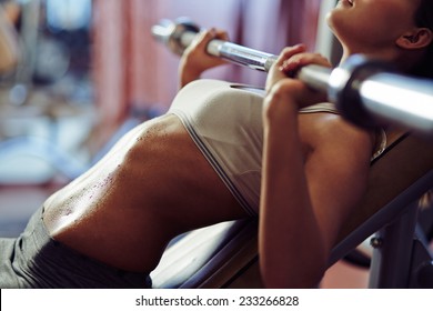 Woman Lifting Weights In Gym