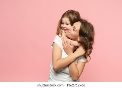 Woman In Light Clothes Have Fun With Cute Child Baby Girl. Mother, Little Kid Daughter Isolated On Pastel Pink Wall Background, Studio Portrait. Mother's Day Love Family, Parenthood Childhood Concept