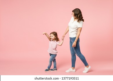 Woman In Light Clothes Have Fun With Cute Child Baby Girl. Mother, Little Kid Daughter Isolated On Pastel Pink Wall Background, Studio Portrait. Mother's Day Love Family, Parenthood Childhood Concept