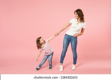 Woman In Light Clothes Have Fun With Cute Child Baby Girl. Mother, Little Kid Daughter Isolated On Pastel Pink Wall Background, Studio Portrait. Mother's Day Love Family, Parenthood Childhood Concept