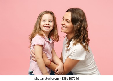 Woman In Light Clothes Have Fun With Cute Child Baby Girl. Mother, Little Kid Daughter Isolated On Pastel Pink Wall Background, Studio Portrait. Mother's Day Love Family, Parenthood Childhood Concept