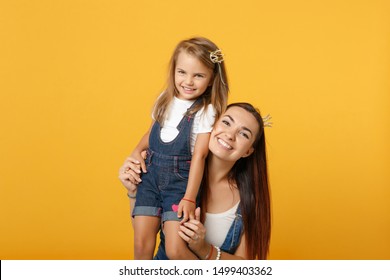 Woman in light clothes have fun with cute child baby girl 4-5 years old. Mommy little kid daughter isolated on yellow background studio portrait. Mother's Day love family parenthood childhood concept - Shutterstock ID 1499403362