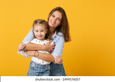 Woman In Light Clothes Have Fun With Cute Child Baby Girl 4-5 Years Old. Mommy Little Kid Daughter Isolated On Yellow Background Studio Portrait. Mother's Day Love Family Parenthood Childhood Concept