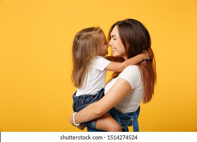 Woman In Light Clothes Have Fun With Cute Child Baby Girl 4-5 Years Old. Mommy Little Kid Daughter Isolated On Yellow Background Studio Portrait. Mother's Day Love Family Parenthood Childhood Concept