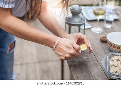 Woman Lighting A Candle With A Lighter. Hand Close Up.