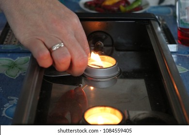 Woman Lighting A Candle With A Matchstick. Hand Close Up 