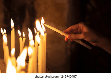 Woman Lighting Candles  In A Church