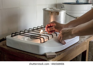 Woman Lights The Match The Gas Stove On Which Stands A Pan By In A Village House