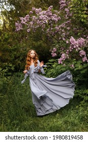 Woman In Lilac Dress In The Garden At Lilac Summer