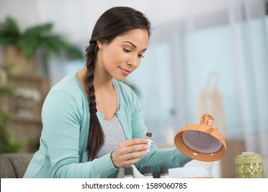 Woman In Lingerie Mixing Essential Oils