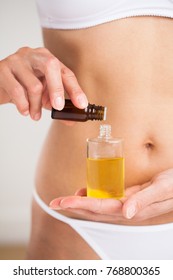 Woman In Lingerie Mixing Essential Oils