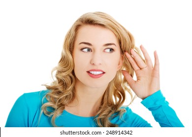 Woman listening gossip with her hand next to her ear - Powered by Shutterstock