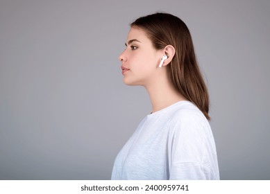 Woman listening to music with earphones. Girl with headphones, wireless earphones. Listening music in earphone, studio. Earphones in ear. Woman using headphones. Ear buds, wireless earbud earphone. - Powered by Shutterstock