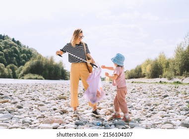 Woman and little girl helping clean up outdoor area from rubbish. Volunteers family collecting plastic waste trash on river beach. People help to keep nature clean up and pick up garbage. - Powered by Shutterstock