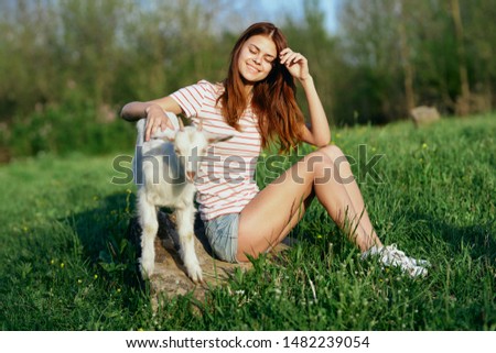 woman with little goat countryside grass fun lifestyle friendship