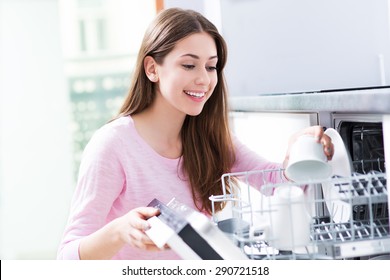 Woman Loading Dishwasher
