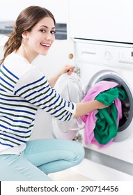 Woman Loading Washing Machine