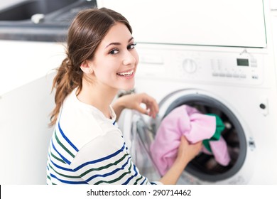 Woman Loading Washing Machine