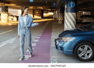 Woman locking her car in underground parking garage as she walks away to shopping mall or home. Lady walking with car keys and smiling