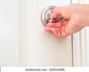 Woman Is Locking Or Unlocking The Round Pocket Door.