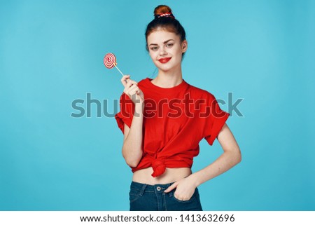 Woman Lollipop Red T-shirt jeans bright makeup and collected hair on his head                   