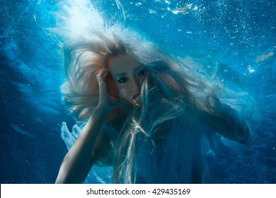 Woman With Long Blonde Hair Under The Water, It Looks Like A Mermaid.