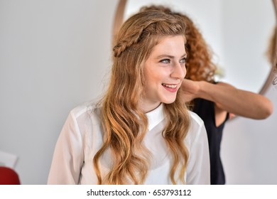 Woman With Long Blonde Yellow Hair With A Braid, Looking To The Right Side.
She Wear White Shirt.