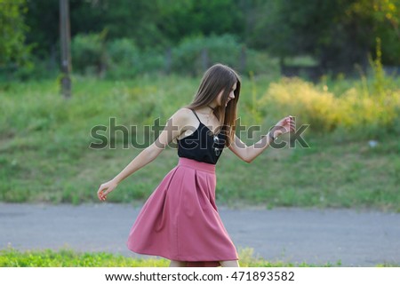 beautiful young woman having fun outside in park