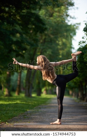 Similar – Young woman doing yoga in nature