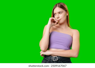 Woman With Long Hair Contemplating While Posing Against a Green Screen - Powered by Shutterstock