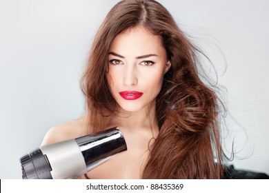 Woman With Long Hair Holding Blow Dryer