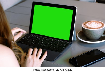 Woman long hair using laptop show blank screen monitor at coffee shop, online working from home concept. - Powered by Shutterstock