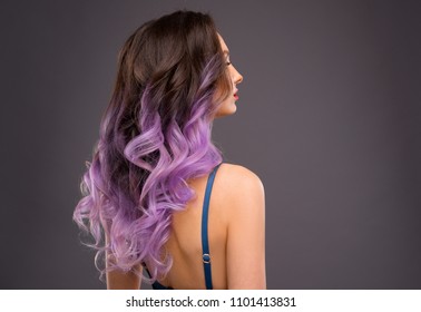 Woman with Long Healthy Colorful Ombre Lavender Wavy Hair. Close Up of Hairstyle. Care and Hair Products