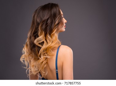 Woman With Long Healthy Colorful Ombre Wavy Hair. Close Up Of Hairstyle. Care And Hair Products