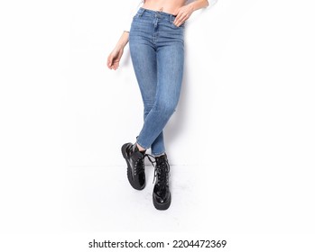 Woman Long Legs In Black  Boots And Denim Jeans Over White Background 