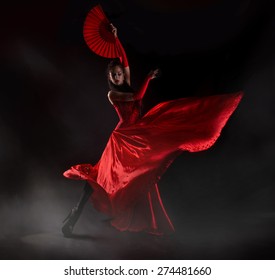  Woman In Long Red Dress Stay In Dancing Pose.