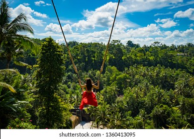 woman with long swing and forest view