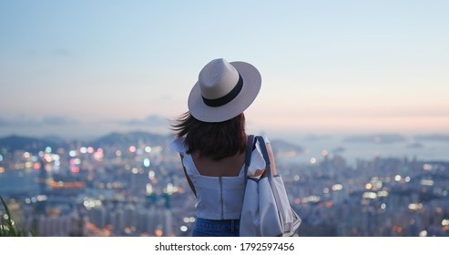 Woman look at the beautiful city view at sunset - Powered by Shutterstock